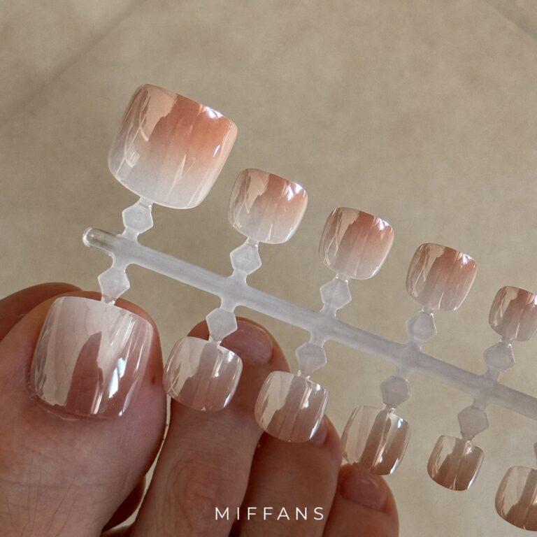 Electroplated aurora blank press-on toe nail tips on a display strip